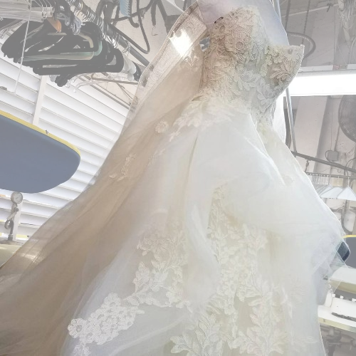 Elegant wedding gown cleaned by Sunny Dry Cleaners